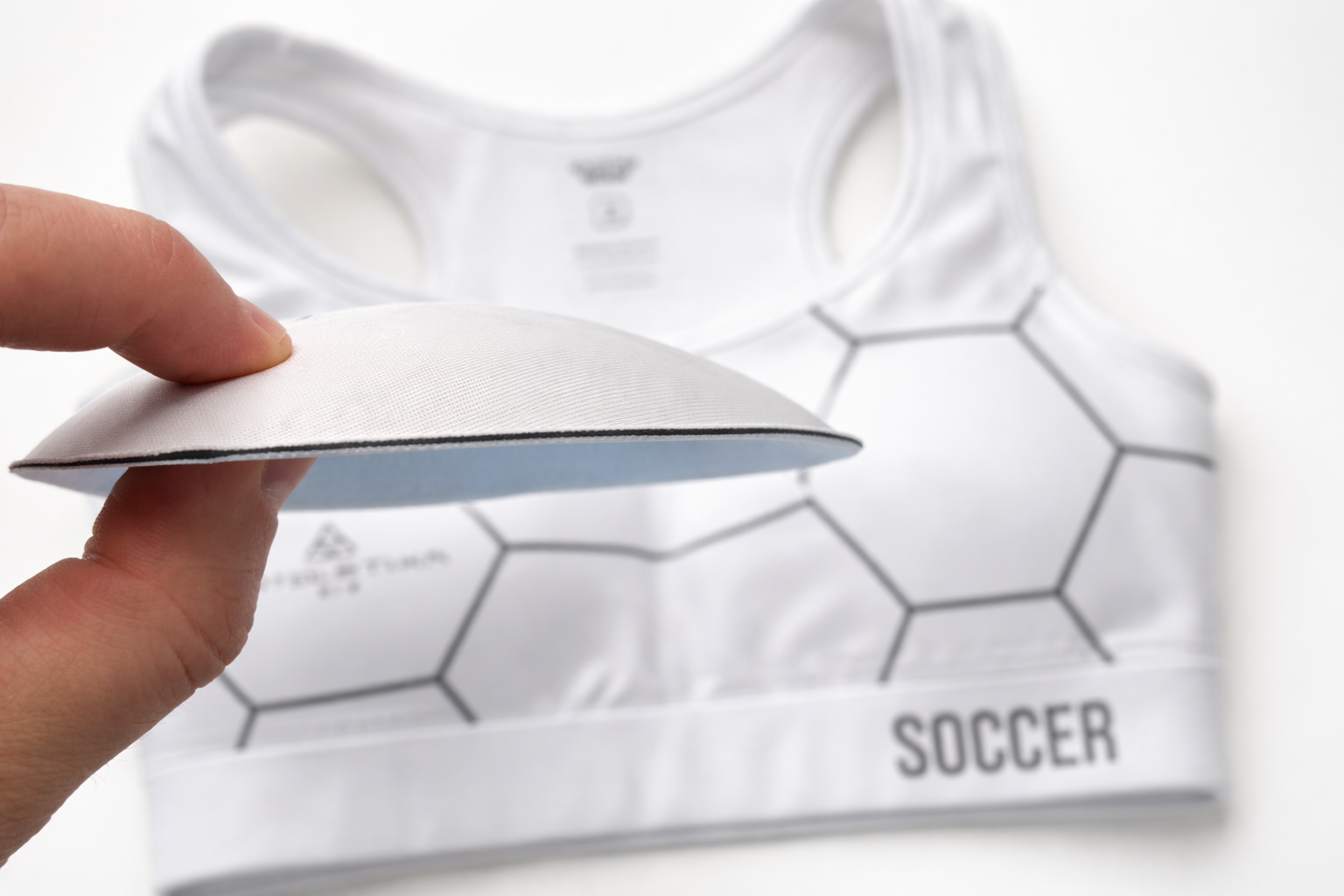 Removable impact pads for Athletika Fit performance soccer sports bra